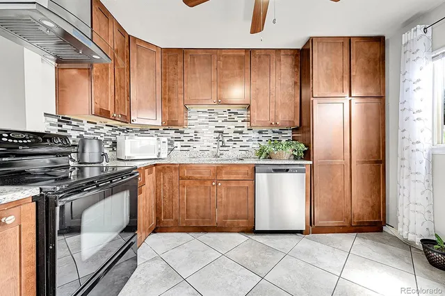 a kitchen with stainless steel appliances granite countertop a stove a refrigerator and a sink