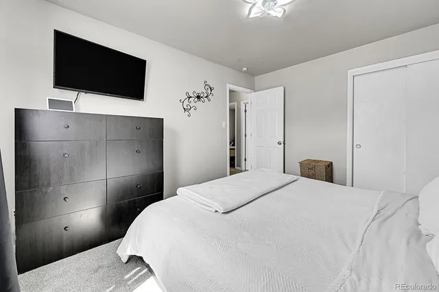 a bedroom with a bed and a flat screen tv