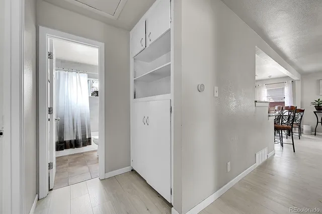 a view of a chair and table in backyard of the house