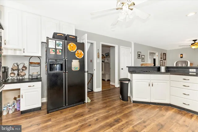a bathroom with a sink a toilet a mirror and shower