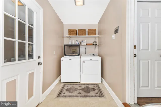 a view of an entryway with wooden floor