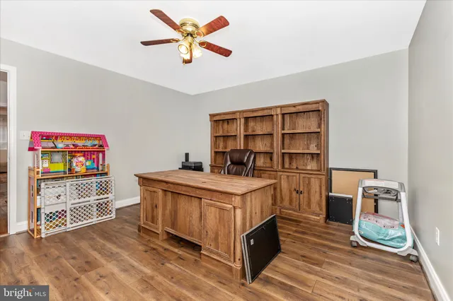 a bed sitting in a room next to a lamp