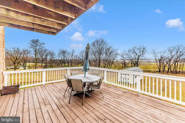 a view of a house with a big yard and large trees