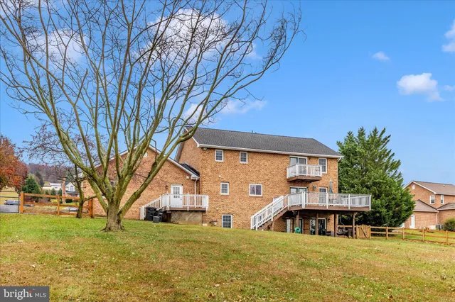 a view of a house with a big yard and large trees