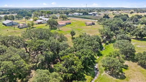 a view of a big yard with large trees