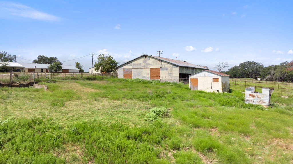 131 Elberta Street Stonewall, TX 78671 - Photo 21 of 71 a view of a big house with a big yard and large trees