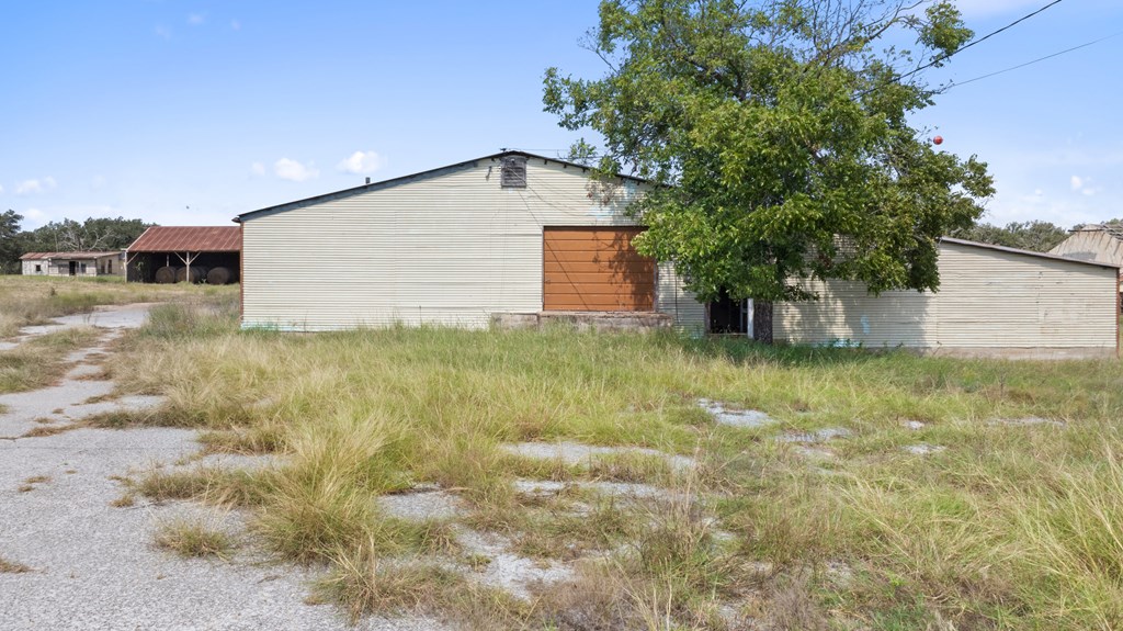 131 Elberta Street Stonewall, TX 78671 - Photo 26 of 71 a backyard of a house with table and chairs