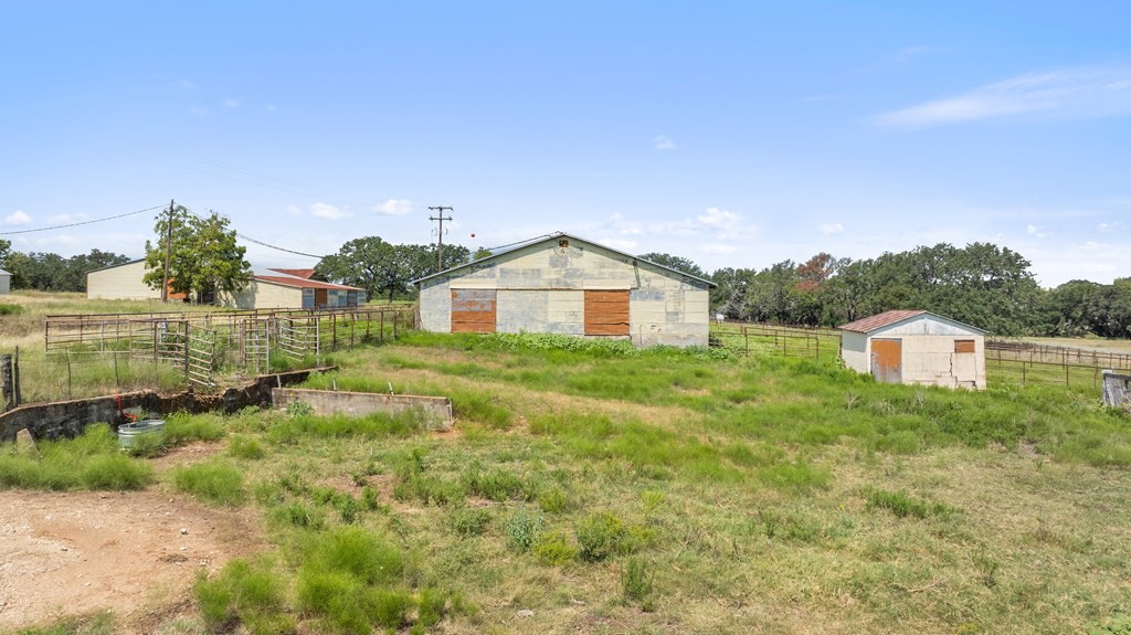 131 Elberta Street Stonewall, TX 78671 - Photo 45 of 71 a view of a house with a yard and a garage