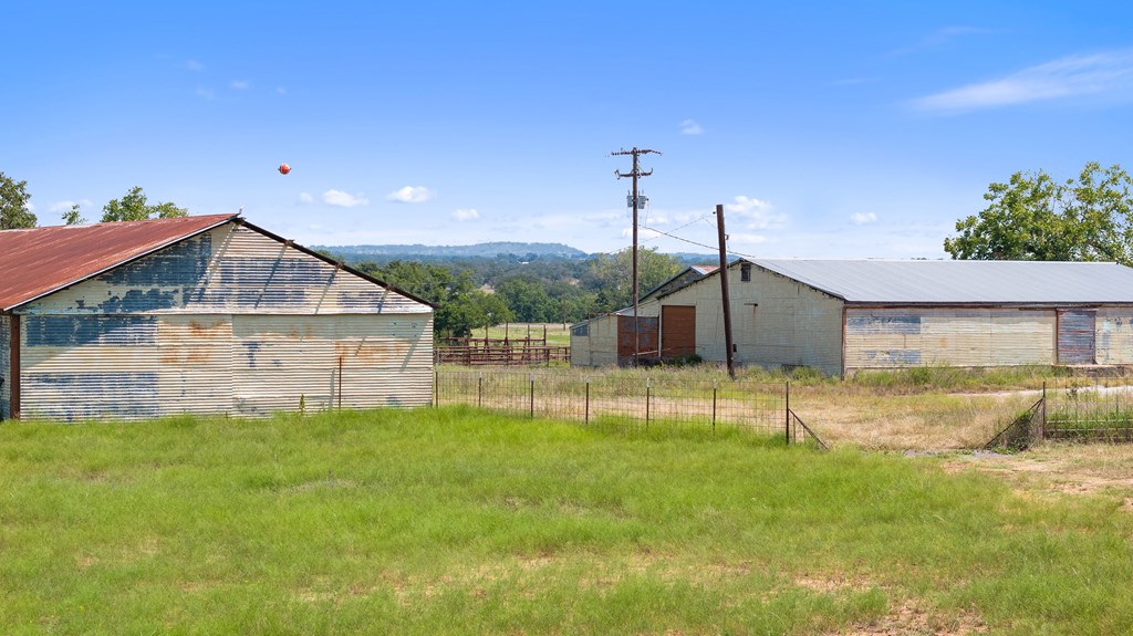131 Elberta Street Stonewall, TX 78671 - Photo 65 of 71 a view of a house with a yard