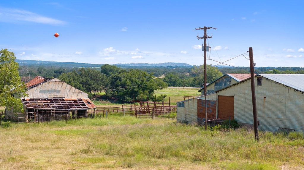 131 Elberta Street Stonewall, TX 78671 - Photo 66 of 71 a view of a house with a backyard and a lake view