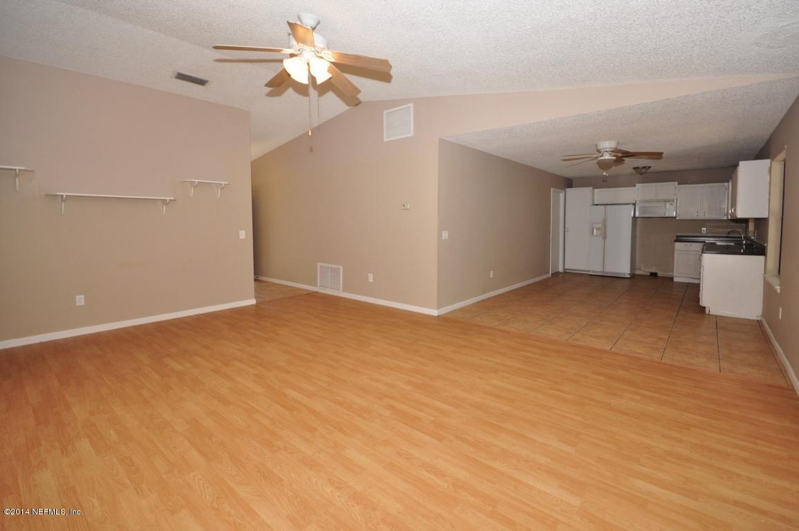 450 Orchis Road St. Augustine, FL 32086 - Photo 3 of 18 a view of a kitchen with a sink and a refrigerator