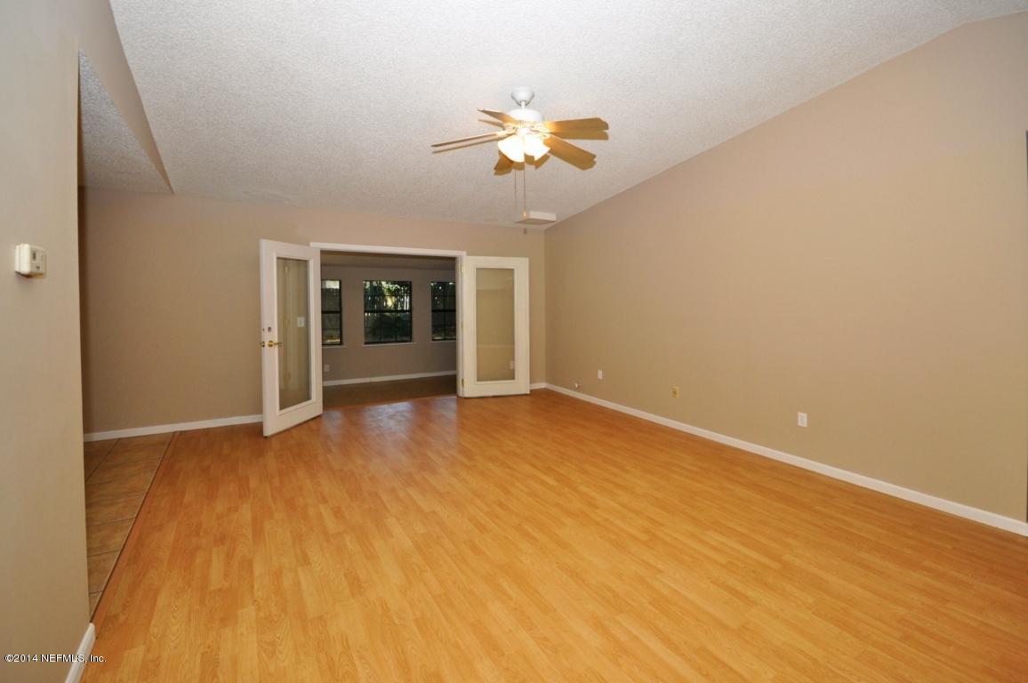 450 Orchis Road St. Augustine, FL 32086 - Photo 4 of 18 wooden floor in an empty room with a window
