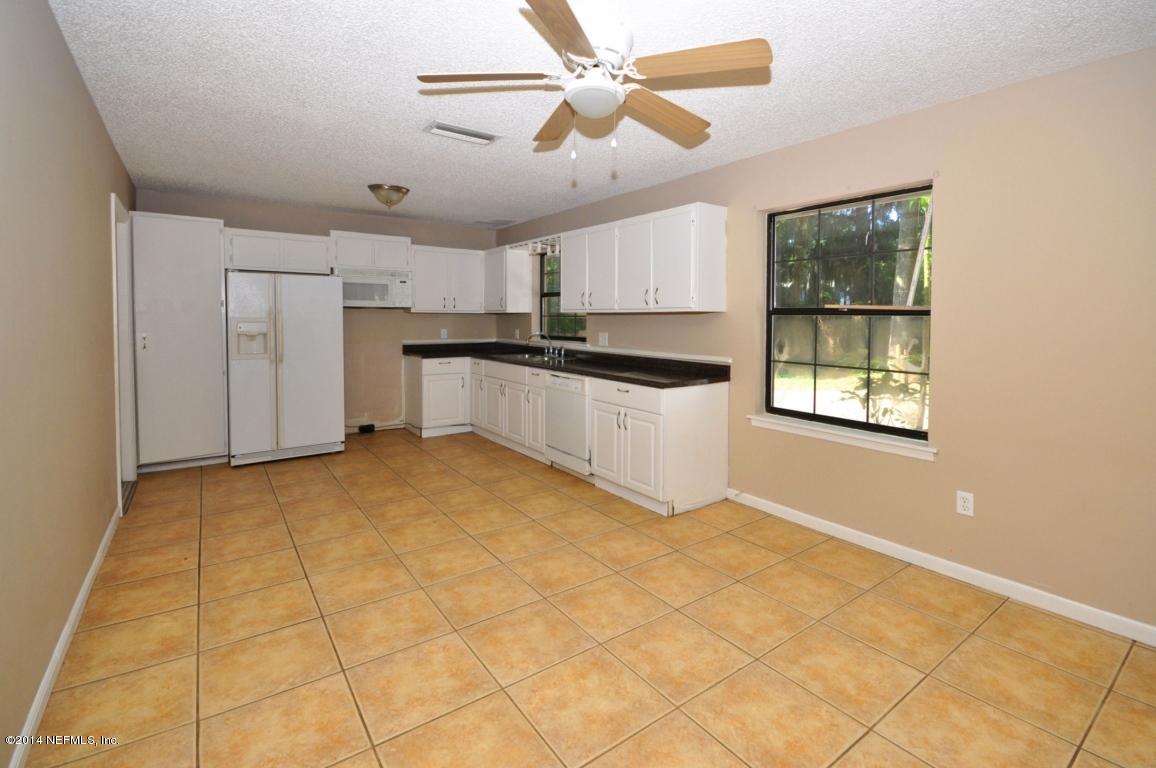 450 Orchis Road St. Augustine, FL 32086 - Photo 5 of 18 a view of a kitchen with a stove and cabinets