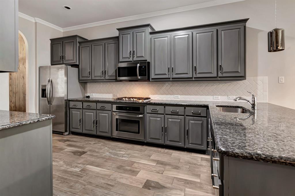 3061 Bella Lago Drive Fort Worth, TX 76177 - Photo 12 of 27 a kitchen with stainless steel appliances granite countertop a stove a sink and a refrigerator