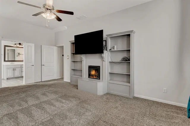 a view of a livingroom with an empty space and a fireplace cabinet