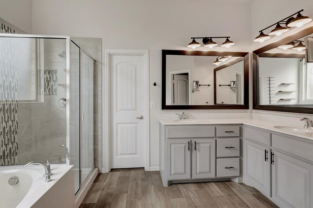3061 Bella Lago Drive Fort Worth, TX 76177 - Photo 16 of 27 a spacious bathroom with a granite countertop sink mirror and a bathtub