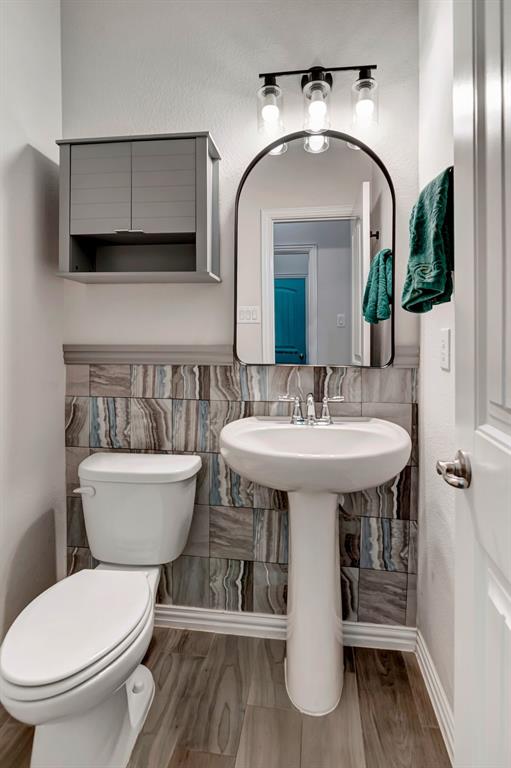 3061 Bella Lago Drive Fort Worth, TX 76177 - Photo 19 of 27 a bathroom with a toilet sink and mirror