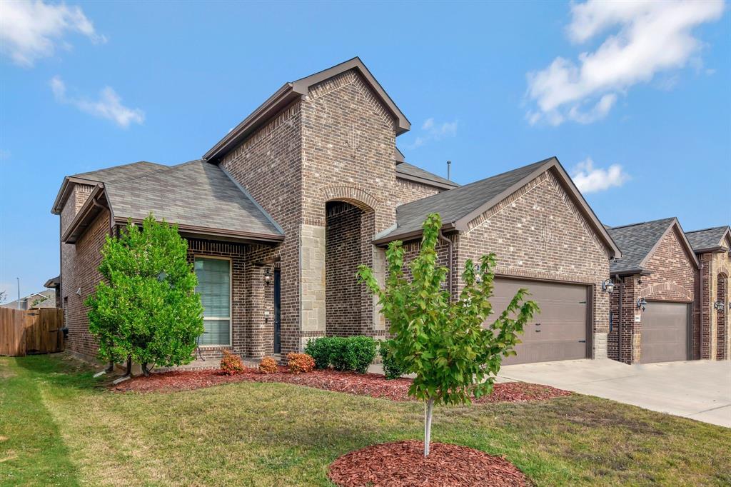 3061 Bella Lago Drive Fort Worth, TX 76177 - Photo 2 of 27 a front view of a house with a yard and potted plants