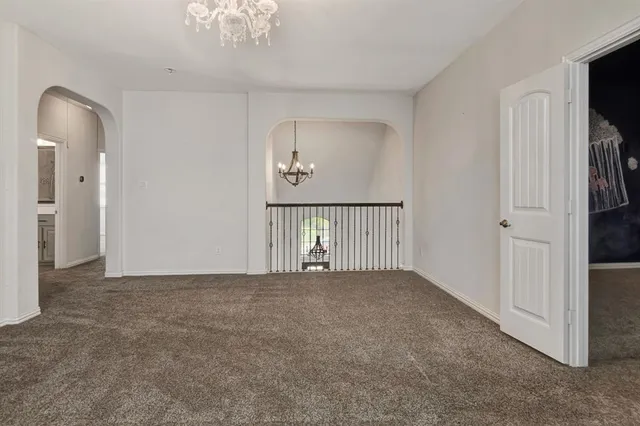 a bedroom with two beds and painting on the wall