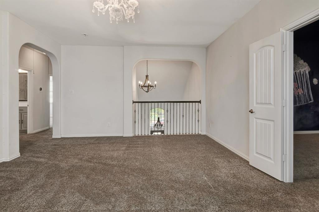 3061 Bella Lago Drive Fort Worth, TX 76177 - Photo 21 of 27 a view of a hallway with a chandelier