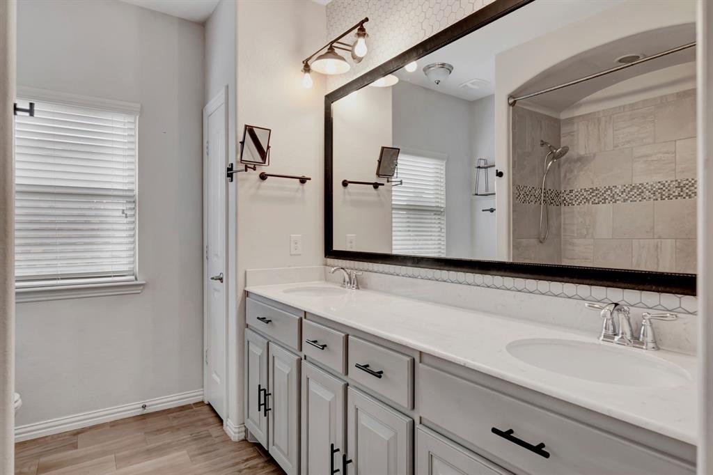 3061 Bella Lago Drive Fort Worth, TX 76177 - Photo 25 of 27 a bathroom with a sink and a mirror