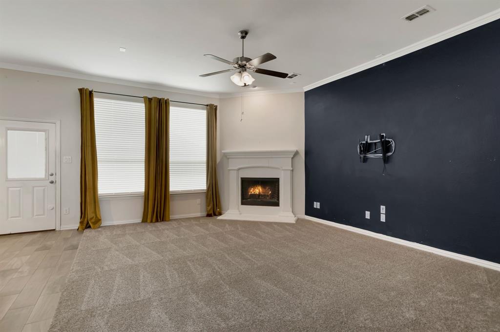3061 Bella Lago Drive Fort Worth, TX 76177 - Photo 7 of 27 a view of an empty room with a fireplace and a window