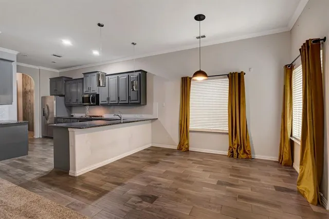a view of kitchen with refrigerator and window