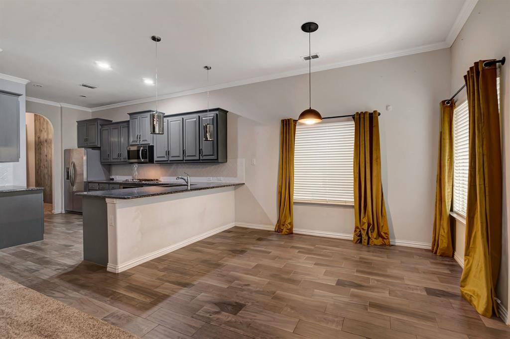 3061 Bella Lago Drive Fort Worth, TX 76177 - Photo 9 of 27 a kitchen with stainless steel appliances granite countertop a refrigerator a sink and a stove