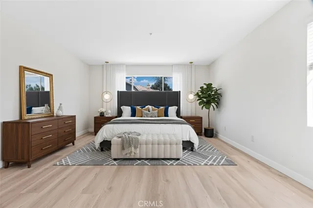 a bedroom with a large bed and a potted plant