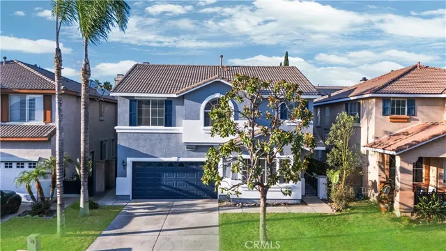 a front view of a house with a garden