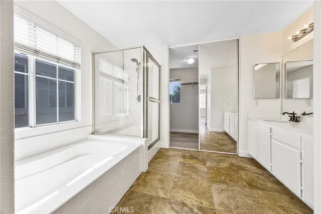 a bathroom with a tub shower and sink