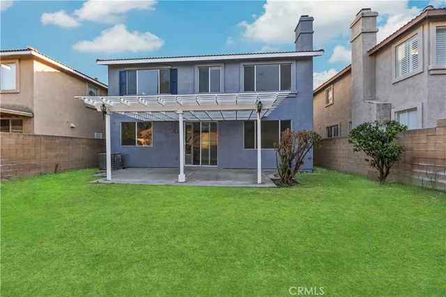 front view of a brick house with a yard
