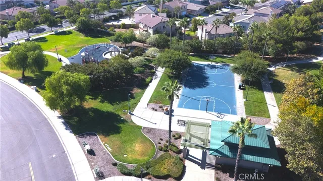 an aerial view of a houses with a yard and outdoor seating