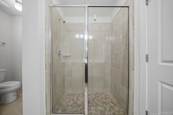 a bathroom with a shower and toilet