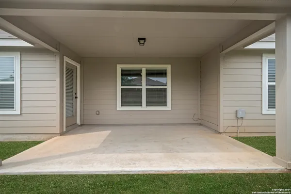 a view of house with backyard and window