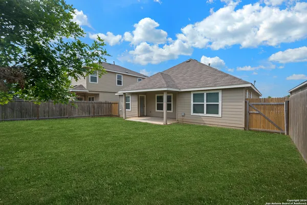 a view of a house with a backyard