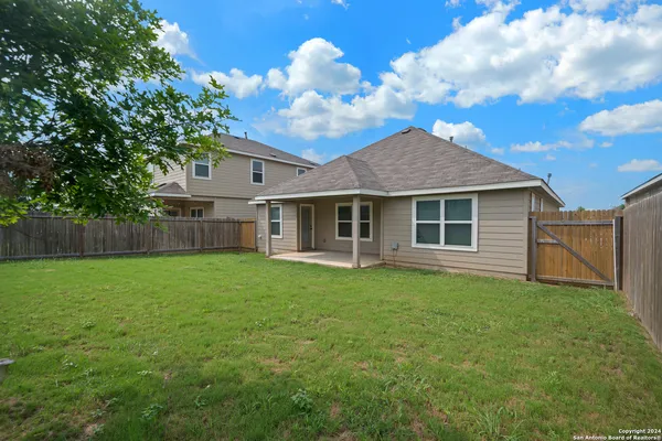 a view of a house with a backyard