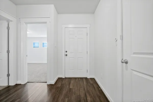 a view of a room with wooden floor
