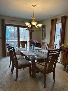 a view of a dining room with furniture and window
