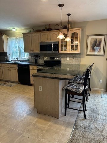 54 Frazier Way Barnstable, MA 02648 - Photo 19 of 31 a kitchen with stainless steel appliances granite countertop a stove top oven a sink a dining table and chairs