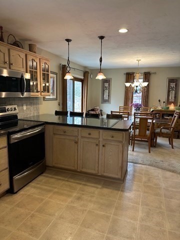 54 Frazier Way Barnstable, MA 02648 - Photo 23 of 31 a kitchen with stainless steel appliances granite countertop a sink a stove top oven a counter space and cabinets