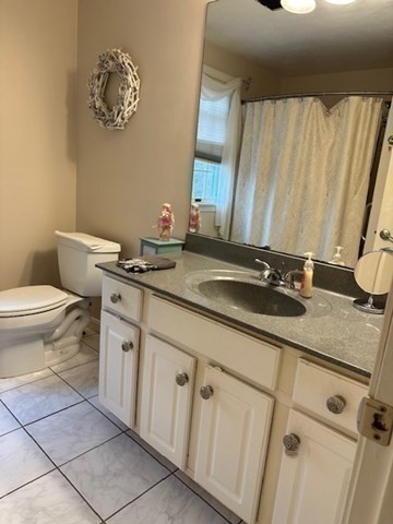 54 Frazier Way Barnstable, MA 02648 - Photo 27 of 31 a bathroom with a granite countertop sink and a toilet