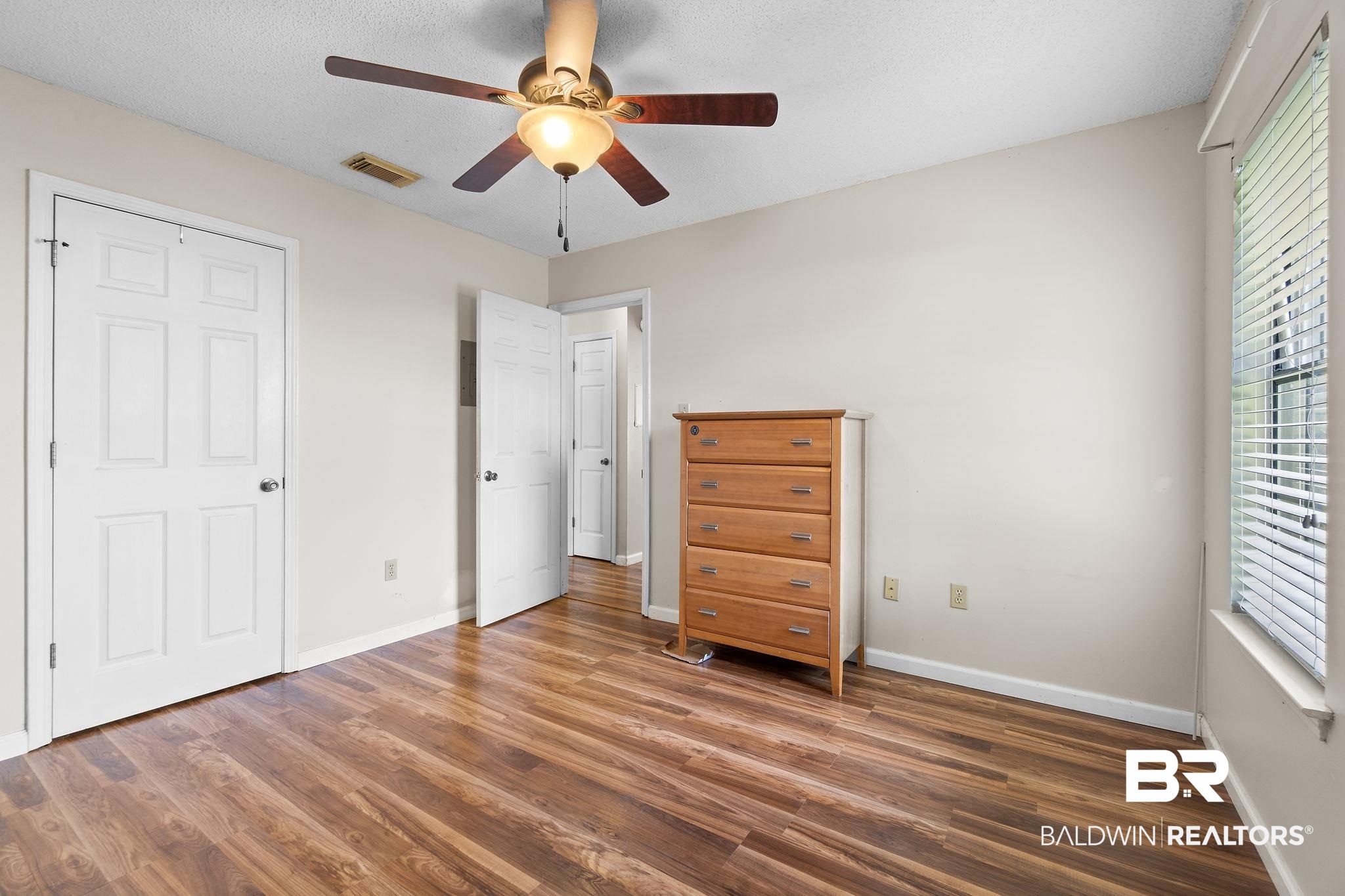 33135 Collier Road Lillian, AL 36549 - Photo 21 of 30 Bedroom with wood finished floors and a ceiling fan
