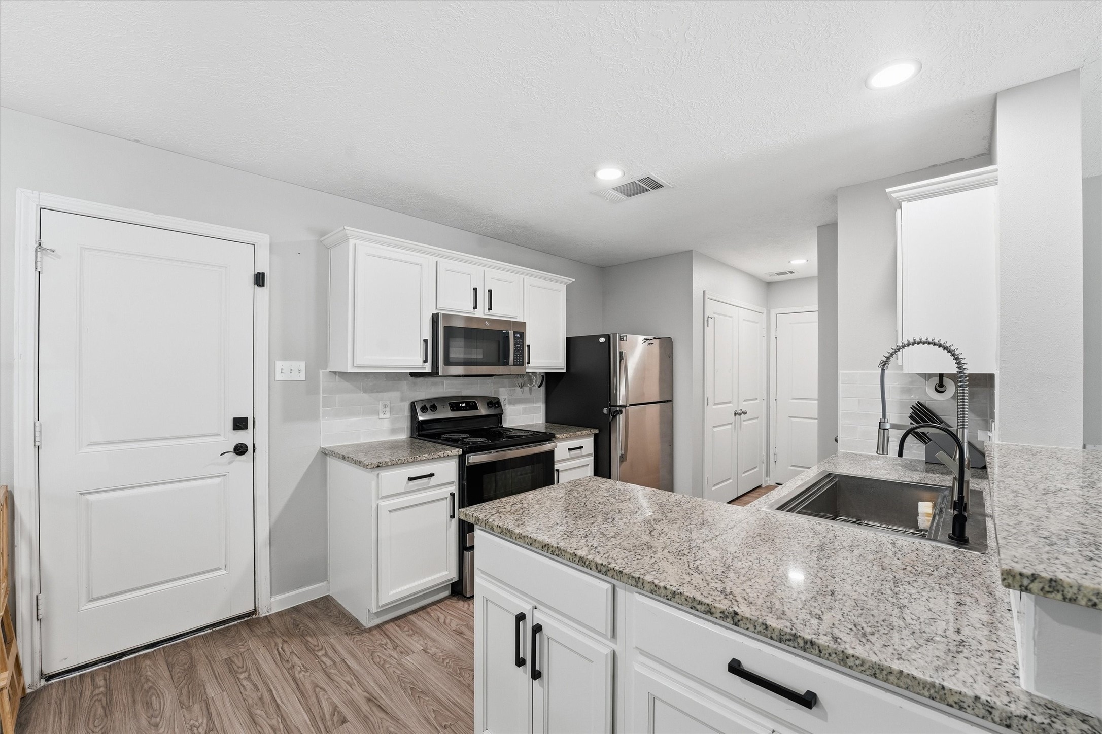 15011 Crockett Road Willis, TX 77378 - Photo 5 of 24 Spacious kitchen with ample countertop space. Refrigerator STAYS with the home.