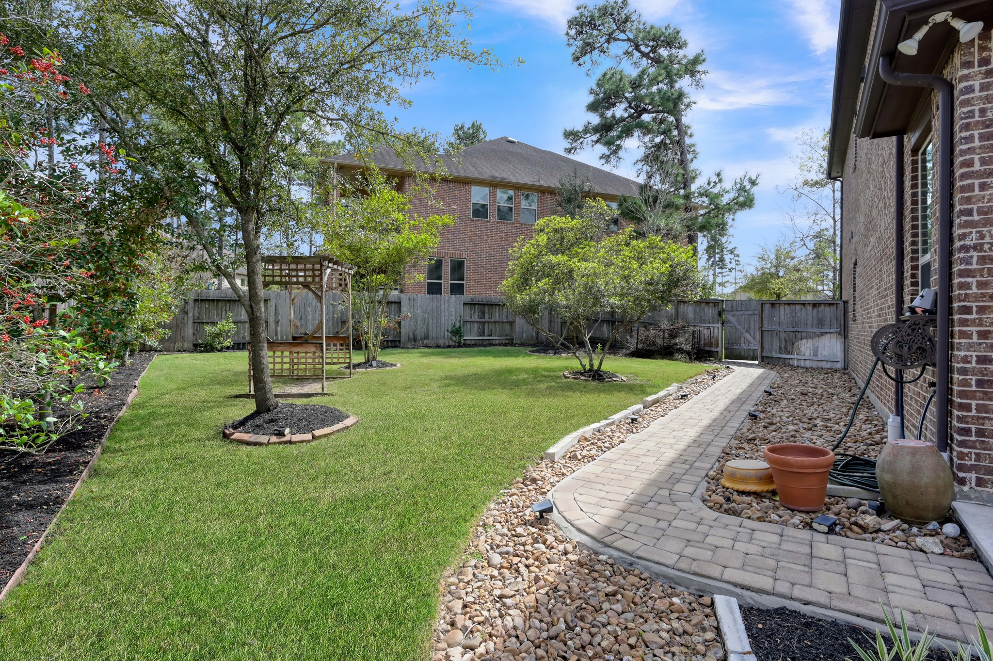 23219 Belted Kingfisher Trail Spring, TX 77389 - Photo 37 of 43 a view of a backyard with plants and a patio