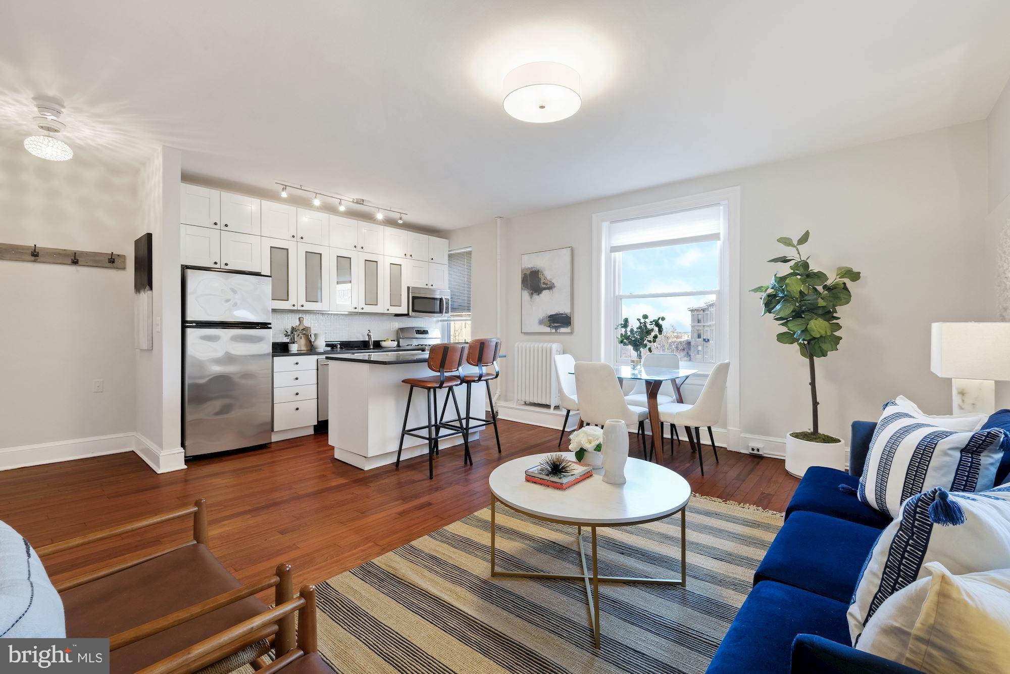 a living room with furniture and kitchen view