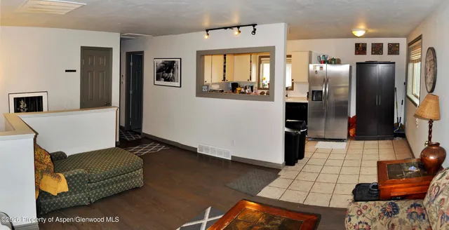a kitchen with stainless steel appliances granite countertop a refrigerator and a stove