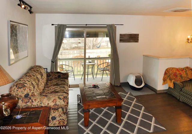 a living room with furniture a couch and a table in it