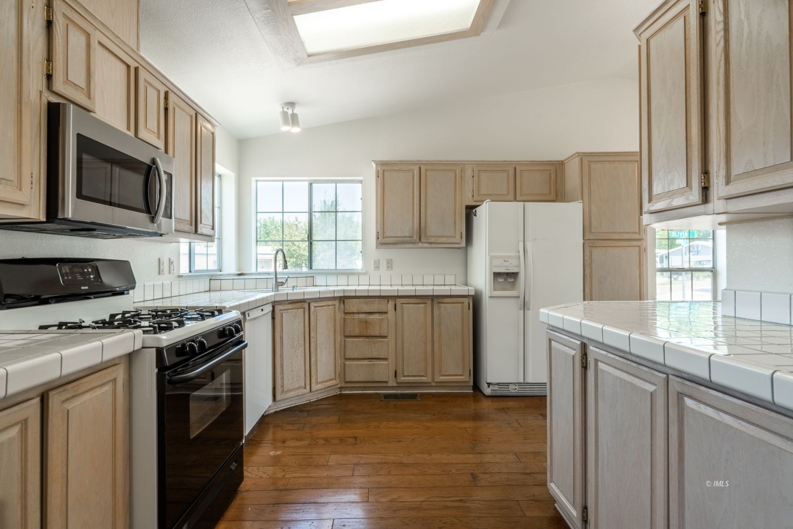 77 Olivia Lane Big Pine, CA 93513 - Photo 11 of 35 a kitchen with a stove a sink and a refrigerator