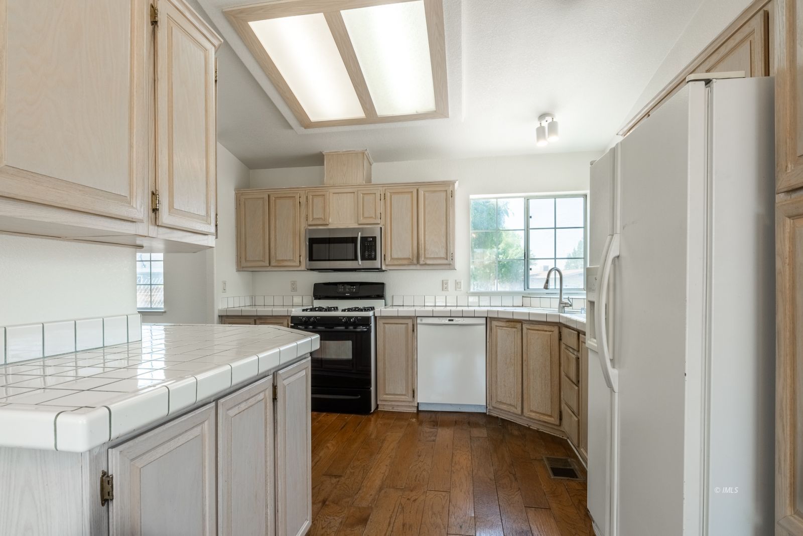 77 Olivia Lane Big Pine, CA 93513 - Photo 12 of 35 a kitchen with stainless steel appliances granite countertop a stove a sink and a refrigerator